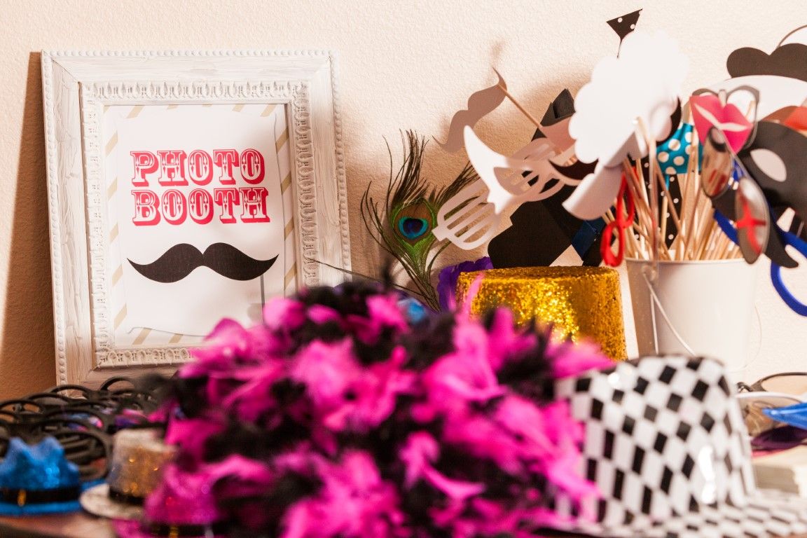 Open-air photo booth set up with props and backdrop